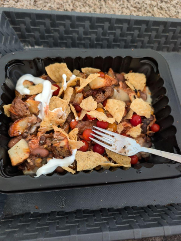 Dinner shredded chicken with some bean mix ed cheese and some grumble chips and some potatoes